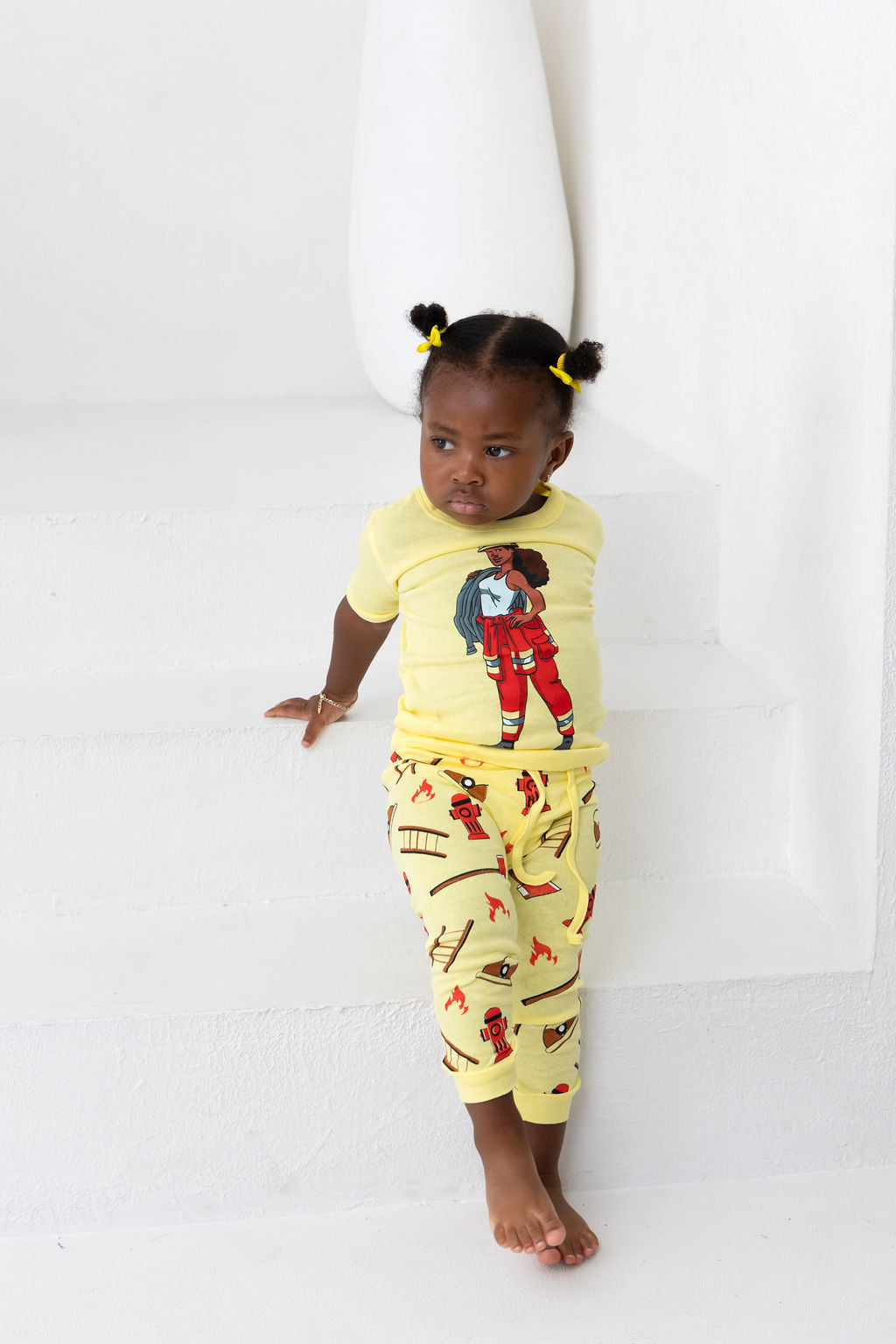 Little Girl wearing Firewoman pajamas