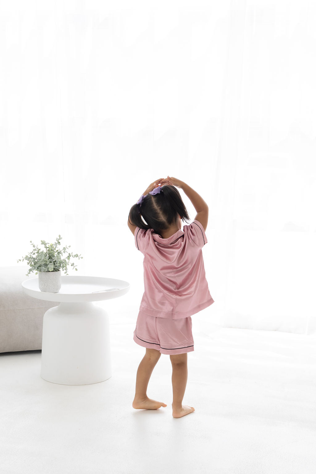 Little girl playing in Satin Pajamas
