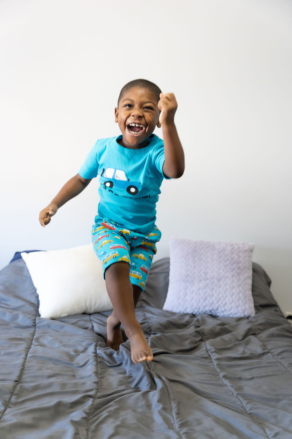 boy jumping on the bed